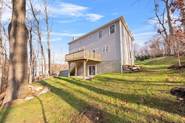 back of property featuring a lawn and a deck