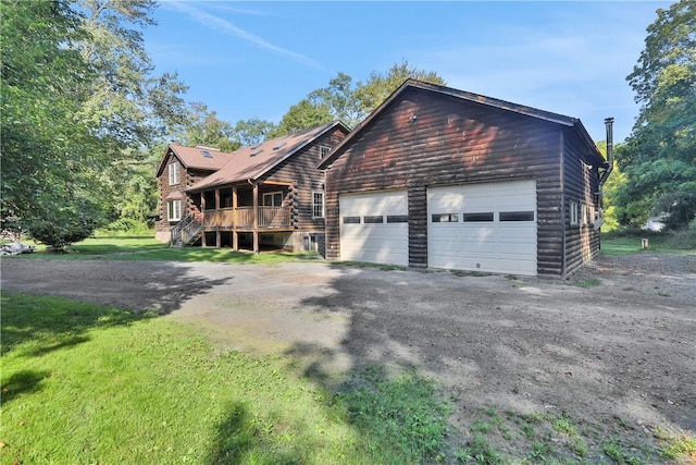 view of front of home with a front yard and a garage