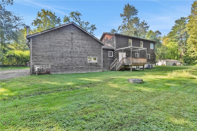 back of house with a yard and a wooden deck