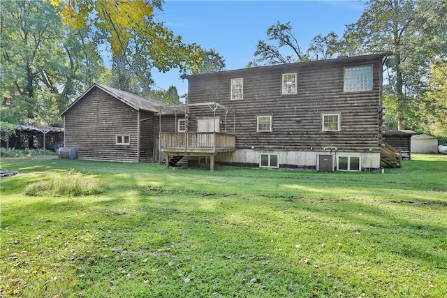 rear view of house with central air condition unit, a yard, and a deck