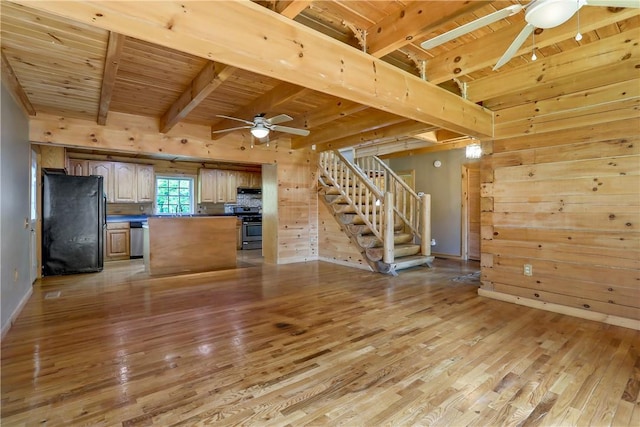 kitchen featuring a center island, stainless steel appliances, wooden walls, wood ceiling, and light wood-type flooring