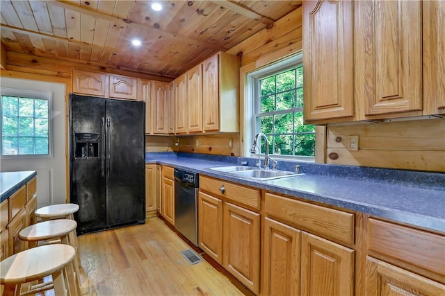 kitchen with light hardwood / wood-style floors, wood ceiling, a wealth of natural light, and black appliances