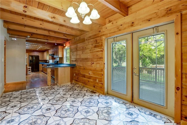 doorway to outside featuring beam ceiling, light wood-type flooring, wooden ceiling, and french doors