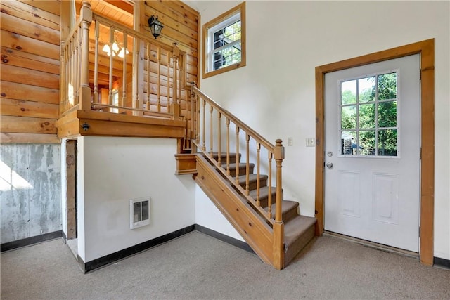 stairs featuring carpet flooring