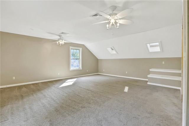 bonus room with ceiling fan, carpet floors, and lofted ceiling with skylight