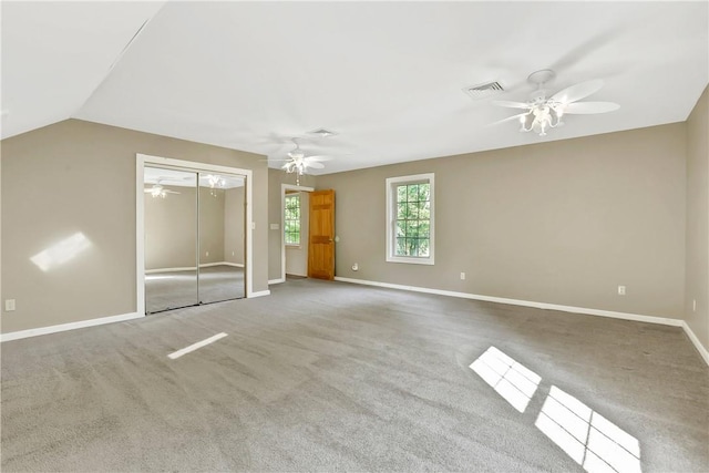 unfurnished bedroom with carpet flooring, ceiling fan, and lofted ceiling