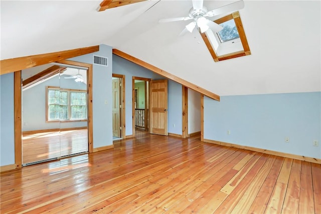 bonus room with hardwood / wood-style flooring, ceiling fan, and lofted ceiling with skylight