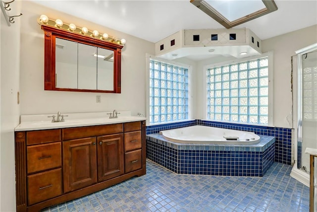 bathroom with tile patterned floors, plus walk in shower, and vanity