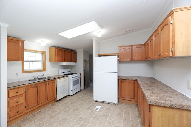 kitchen with white appliances, vaulted ceiling with skylight, crown molding, and sink