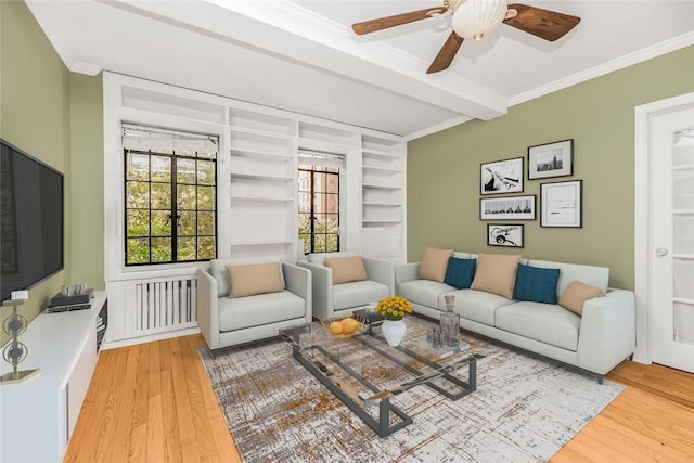 living room with beamed ceiling, a healthy amount of sunlight, and light wood-type flooring