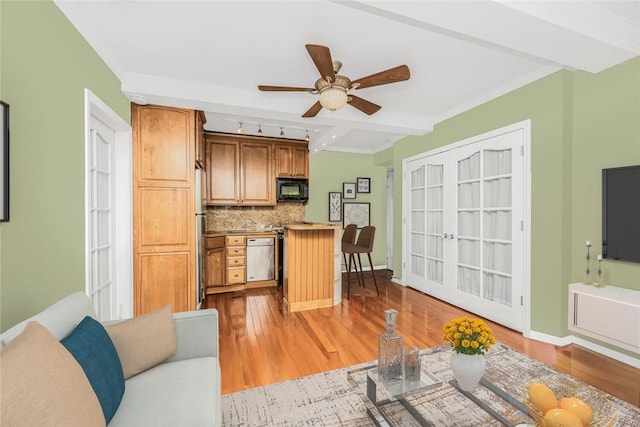 living room featuring beamed ceiling, ceiling fan, light hardwood / wood-style floors, and ornamental molding