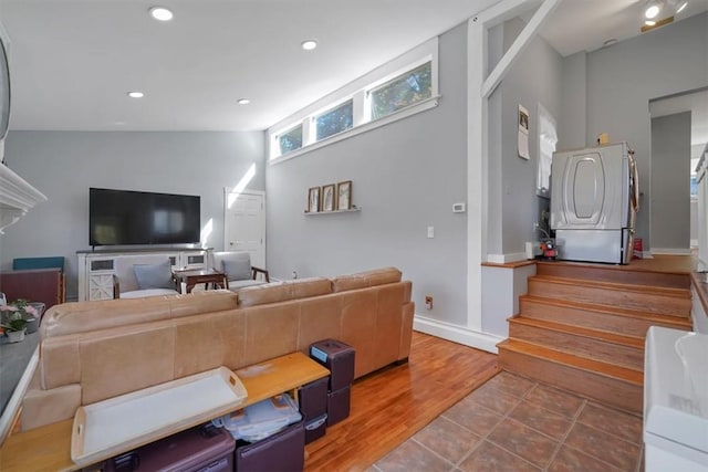 living room featuring hardwood / wood-style floors and high vaulted ceiling