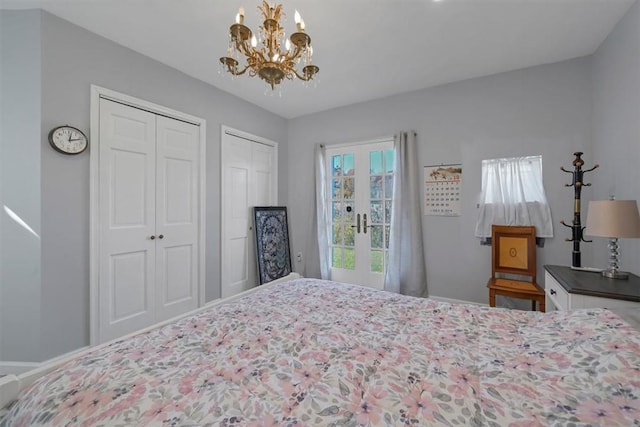 bedroom featuring french doors, two closets, and a notable chandelier