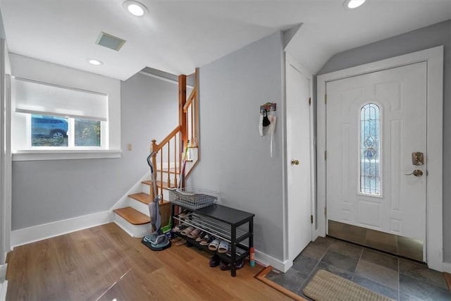 entrance foyer featuring dark hardwood / wood-style flooring and vaulted ceiling