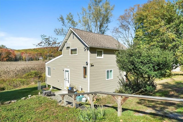 rear view of property with a yard