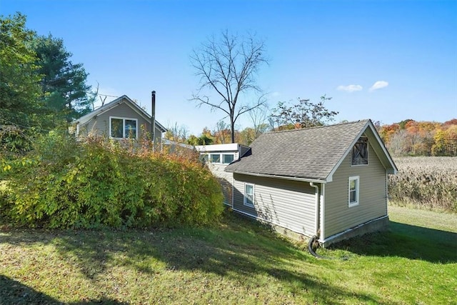 view of side of property with a lawn