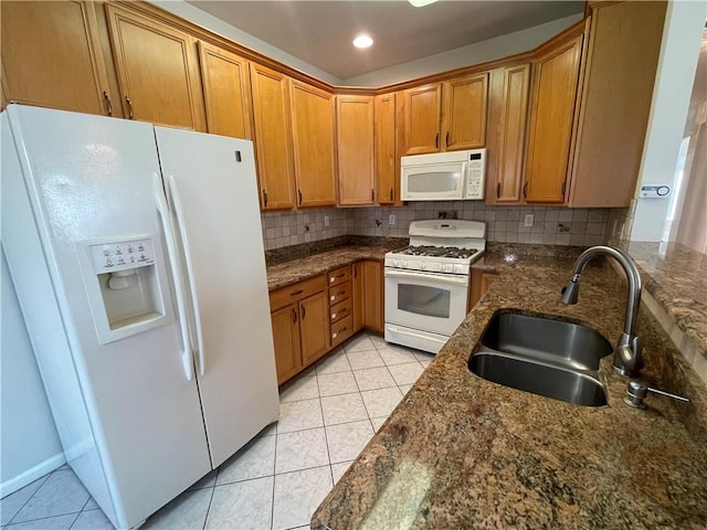 kitchen with tasteful backsplash, sink, light tile patterned flooring, and white appliances