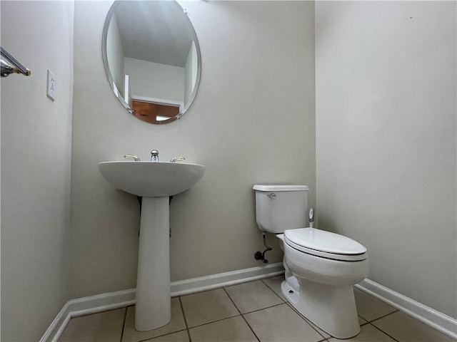 bathroom featuring tile patterned flooring and toilet