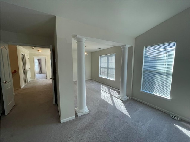 carpeted empty room featuring plenty of natural light and lofted ceiling