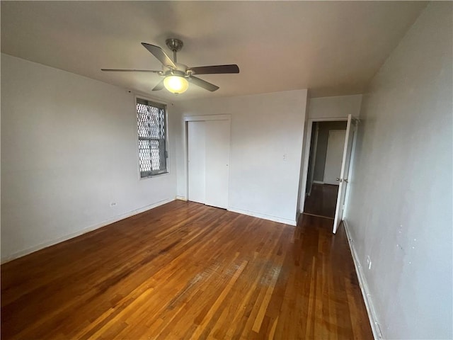 unfurnished bedroom featuring a closet, dark hardwood / wood-style floors, and ceiling fan