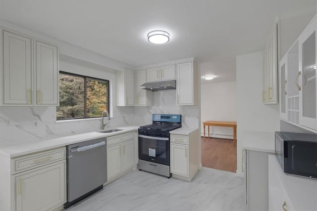 kitchen featuring backsplash, sink, white cabinetry, and stainless steel appliances