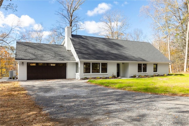 single story home featuring a garage and a front lawn