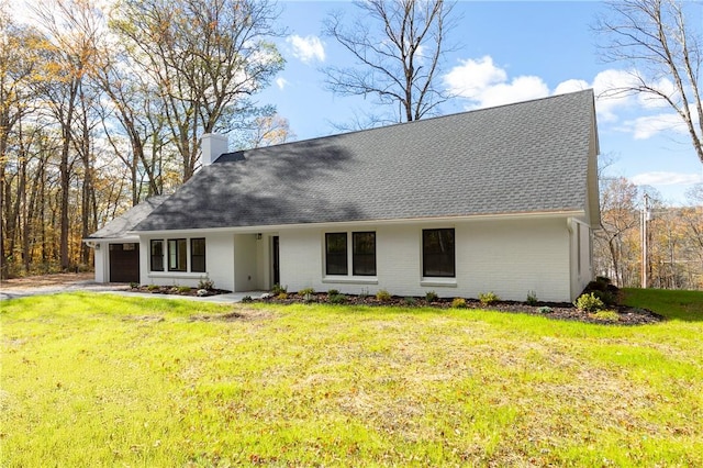 view of front facade with a front yard and a garage