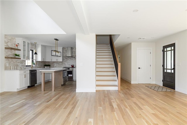 foyer with sink, light hardwood / wood-style flooring, and beamed ceiling