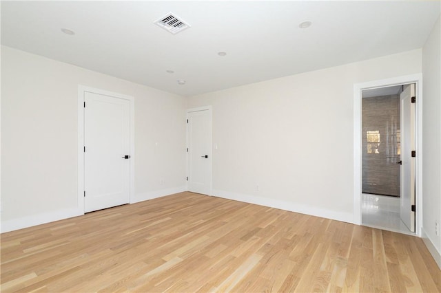 spare room featuring light hardwood / wood-style flooring