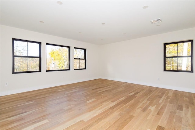 unfurnished room featuring light hardwood / wood-style floors