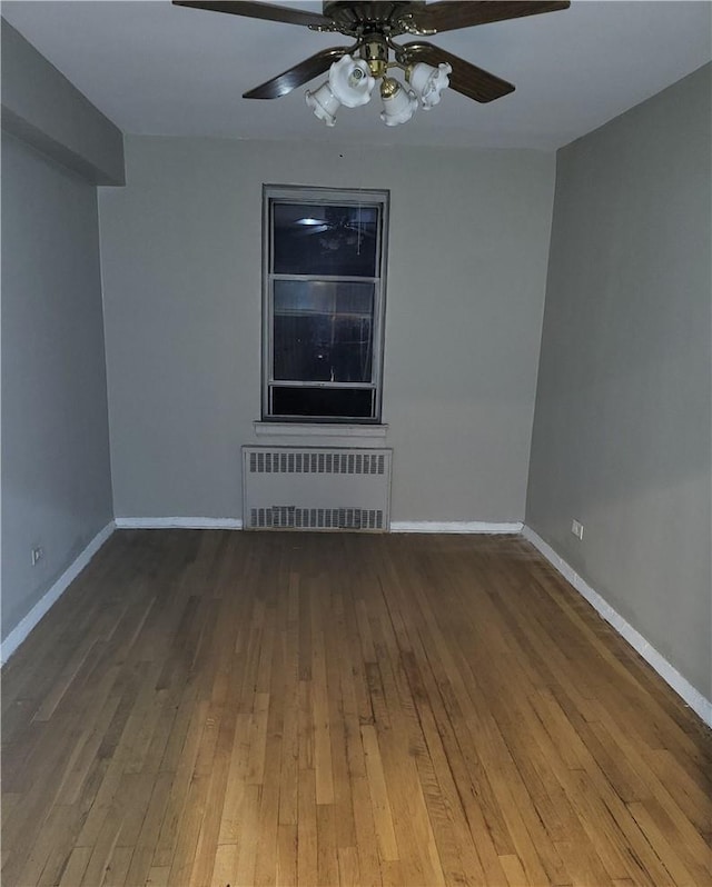800 Grand Concourse Unit 4G-N, Bronx, NY 10451 - empty room with radiator heating unit, hardwood / wood-style flooring, and baseboards