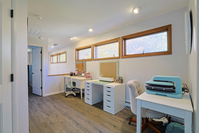 home office with light wood-type flooring, baseboard heating, baseboards, and recessed lighting