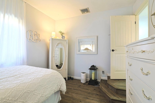 bedroom with dark wood-type flooring, visible vents, and baseboards