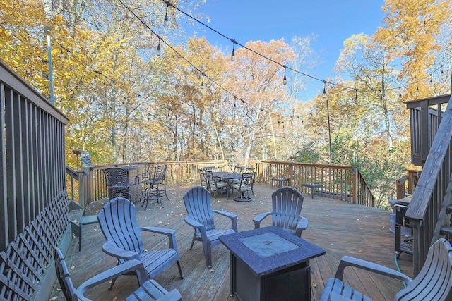 wooden deck featuring an outdoor fire pit and outdoor dining area