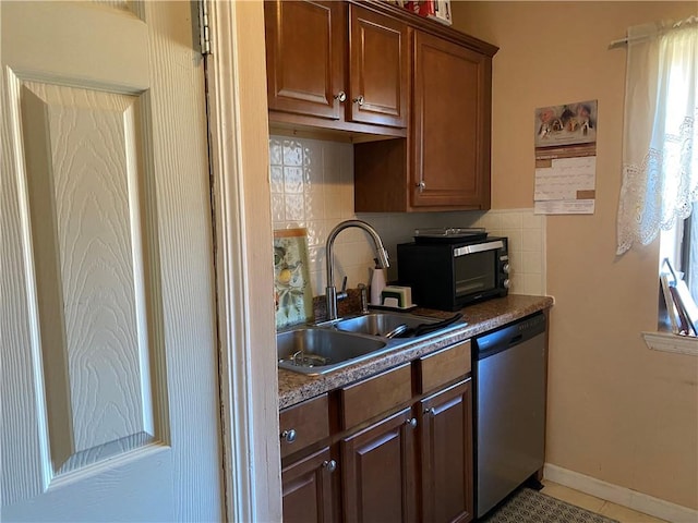 kitchen with stainless steel dishwasher, light tile patterned floors, sink, and tasteful backsplash