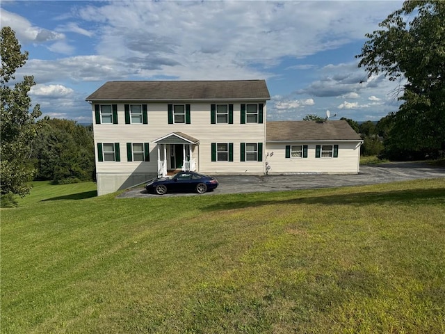 colonial inspired home with a front yard