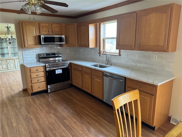 kitchen featuring dark hardwood / wood-style flooring, sink, appliances with stainless steel finishes, and tasteful backsplash