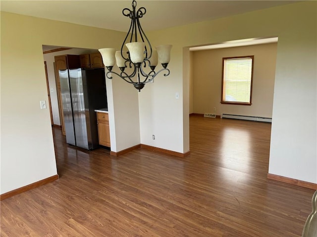 unfurnished dining area with baseboard heating, a chandelier, and dark hardwood / wood-style floors