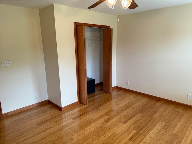 unfurnished bedroom featuring a closet, light hardwood / wood-style floors, and ceiling fan