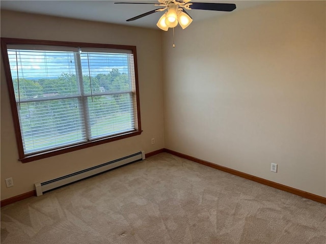 empty room featuring light carpet, ceiling fan, and a baseboard heating unit