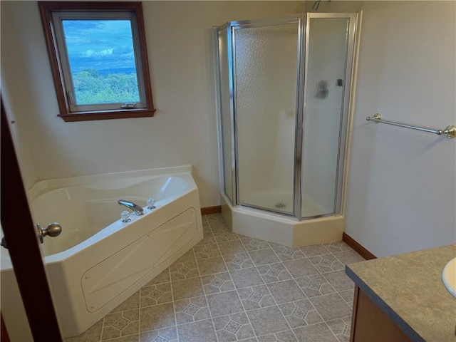 bathroom featuring tile patterned flooring, vanity, and shower with separate bathtub