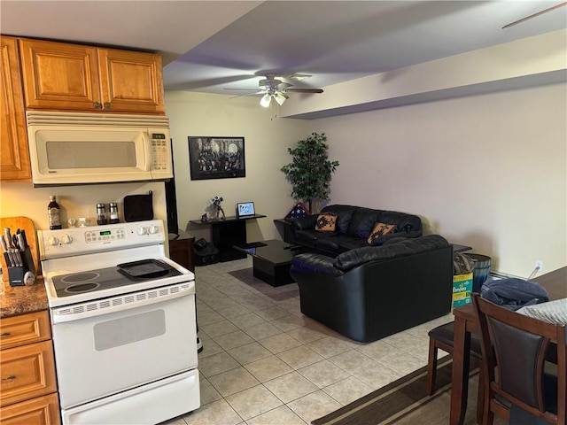 kitchen featuring ceiling fan, light tile patterned flooring, and white appliances