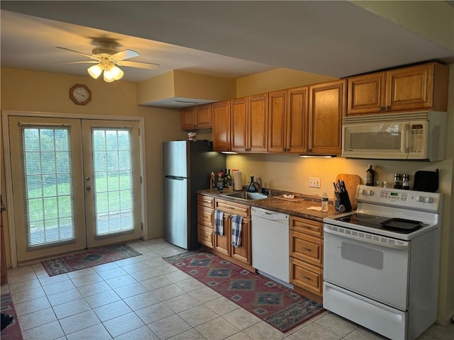 kitchen featuring ceiling fan, light tile patterned flooring, white appliances, and sink