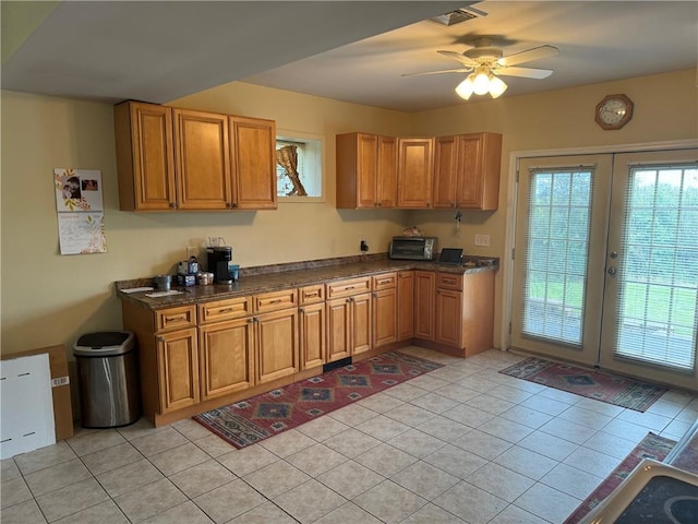 kitchen featuring ceiling fan, light tile patterned floors, and french doors