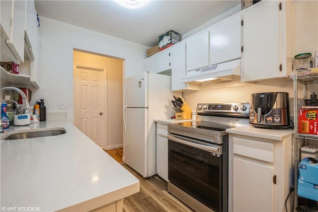 kitchen featuring premium range hood, sink, electric stove, light hardwood / wood-style flooring, and white cabinets