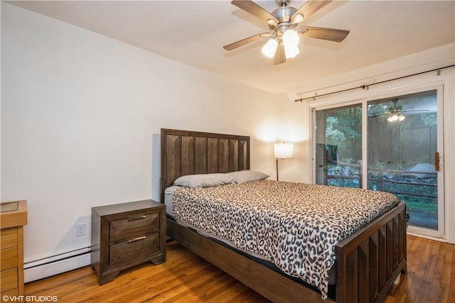 bedroom with hardwood / wood-style floors, ceiling fan, and baseboard heating