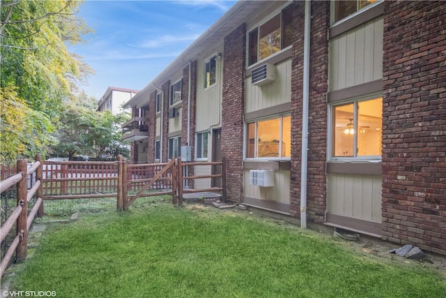 view of yard featuring a wall unit AC