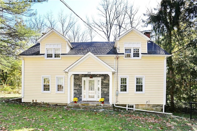 view of front facade with french doors and a front lawn