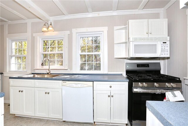 kitchen featuring sink, white cabinets, a healthy amount of sunlight, and white appliances