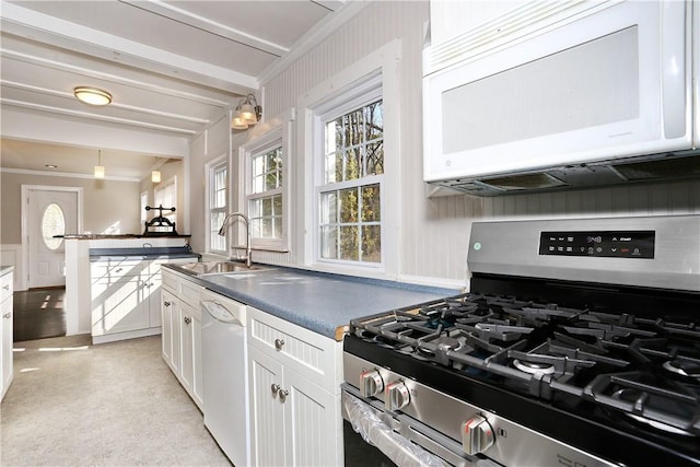 kitchen with white appliances, white cabinets, sink, decorative backsplash, and ornamental molding